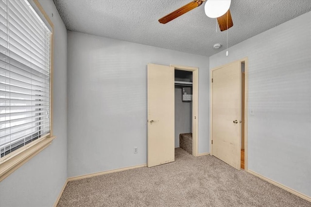 15001 Garr Pl, Oklahoma City, OK 73165 - unfurnished bedroom featuring a textured ceiling, carpet flooring, a ceiling fan, a closet, and baseboards