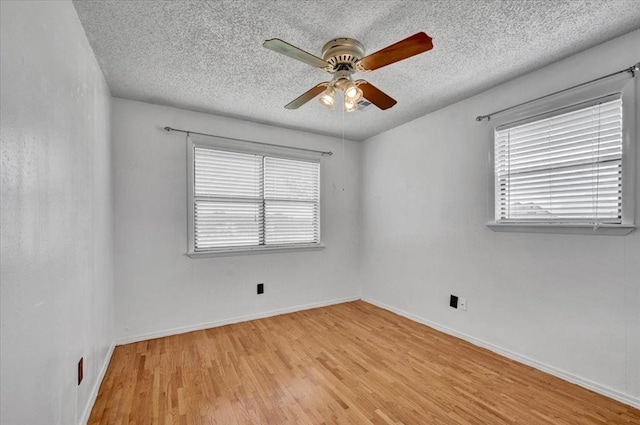 15001 Garr Pl, Oklahoma City, OK 73165 - spare room with ceiling fan, light wood-type flooring, a textured ceiling, and baseboards