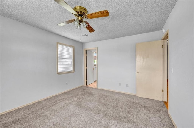 15001 Garr Pl, Oklahoma City, OK 73165 - empty room with a textured ceiling, ceiling fan, light colored carpet, and baseboards