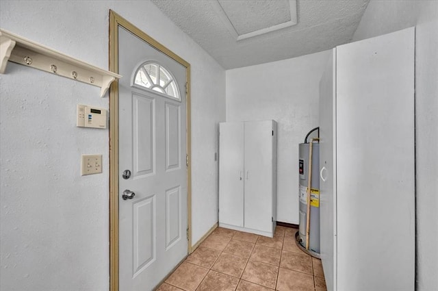 15001 Garr Pl, Oklahoma City, OK 73165 - doorway to outside with electric water heater, light tile patterned floors, and a textured ceiling
