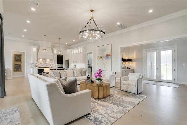 15012 Annecy Blvd, Oklahoma City, OK 73142 - living room with recessed lighting, light wood finished floors, a chandelier, french doors, and baseboards