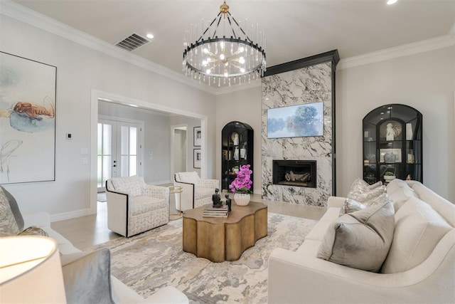 15012 Annecy Blvd, Oklahoma City, OK 73142 - living room featuring crown molding, a premium fireplace, a chandelier, baseboards, and french doors