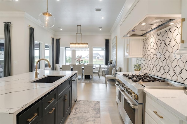 15012 Annecy Blvd, Oklahoma City, OK 73142 - kitchen with double oven range, a sink, premium range hood, light wood-style flooring, and dark cabinetry