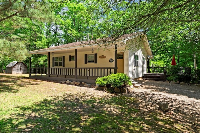 868 Red Fox Rd, Broken Bow, OK 74728 - view of front of house with a shed, an outdoor structure, and a porch