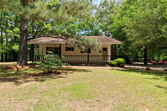 868 Red Fox Rd, Broken Bow, OK 74728 - rear view of house featuring covered porch and a lawn