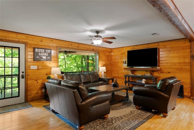 868 Red Fox Rd, Broken Bow, OK 74728 - living area featuring healthy amount of natural light, wood walls, ceiling fan, and light wood-type flooring