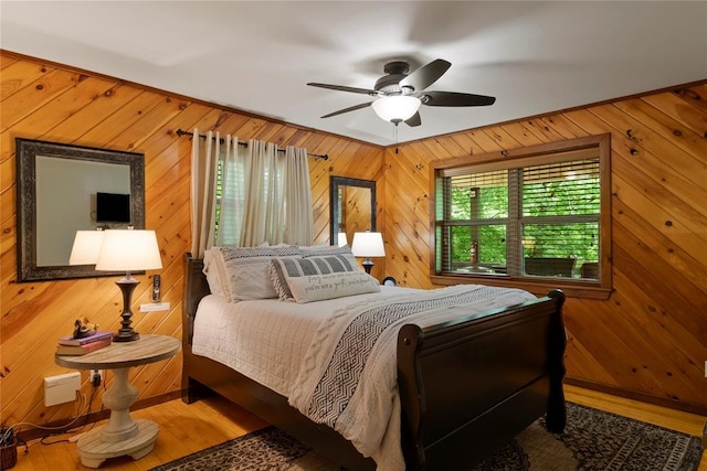 868 Red Fox Rd, Broken Bow, OK 74728 - bedroom with wood walls, wood finished floors, and a ceiling fan