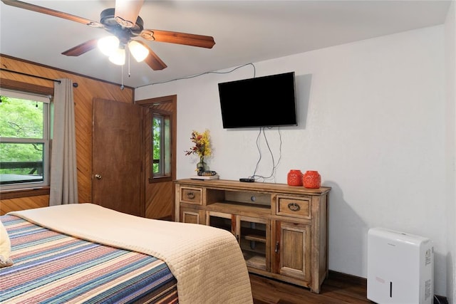 868 Red Fox Rd, Broken Bow, OK 74728 - bedroom with dark wood-style flooring, ceiling fan, and baseboards