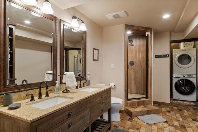 868 Red Fox Rd, Broken Bow, OK 74728 - bathroom with stacked washing machine and dryer, a stall shower, toilet, double vanity, and baseboards