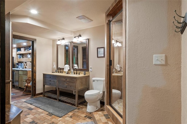 868 Red Fox Rd, Broken Bow, OK 74728 - full bath with toilet, vanity, a textured wall, brick patterned flooring, and baseboards