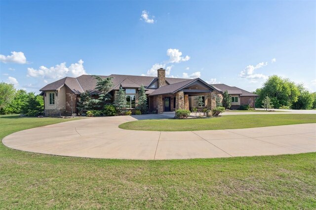 13600 W Britton Rd, Yukon, OK 73099 - view of front of property with curved driveway, a front yard, and a chimney