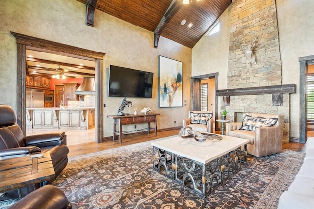 13600 W Britton Rd, Yukon, OK 73099 - living area with wood finished floors, wooden ceiling with exposed beams, a ceiling fan, high vaulted ceiling, and baseboards