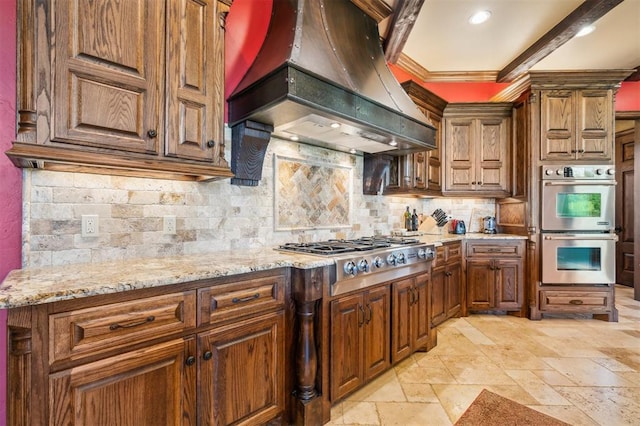 13600 W Britton Rd, Yukon, OK 73099 - kitchen with custom exhaust hood, appliances with stainless steel finishes, stone tile flooring, backsplash, and light stone counters