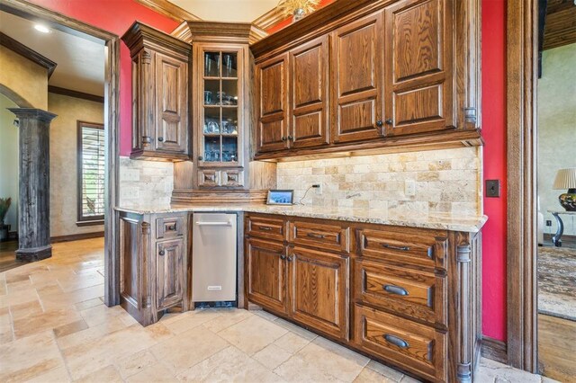 13600 W Britton Rd, Yukon, OK 73099 - kitchen featuring ornate columns, tasteful backsplash, stone tile floors, crown molding, and light stone countertops