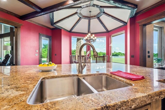 13600 W Britton Rd, Yukon, OK 73099 - kitchen featuring a sink, a chandelier, light stone countertops, hanging light fixtures, and beam ceiling