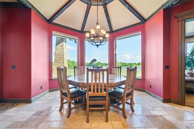 13600 W Britton Rd, Yukon, OK 73099 - dining area featuring stone tile flooring, a chandelier, baseboards, healthy amount of natural light, and vaulted ceiling
