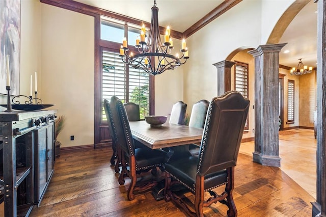 13600 W Britton Rd, Yukon, OK 73099 - dining room with a chandelier, arched walkways, ornate columns, ornamental molding, and hardwood / wood-style floors