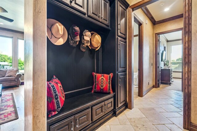 13600 W Britton Rd, Yukon, OK 73099 - mudroom with crown molding, stone tile flooring, baseboards, and ceiling fan