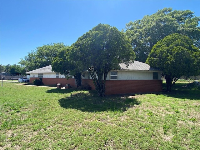 20403 E County Road 1567, Altus, OK 73521 - view of side of home featuring a yard and brick siding