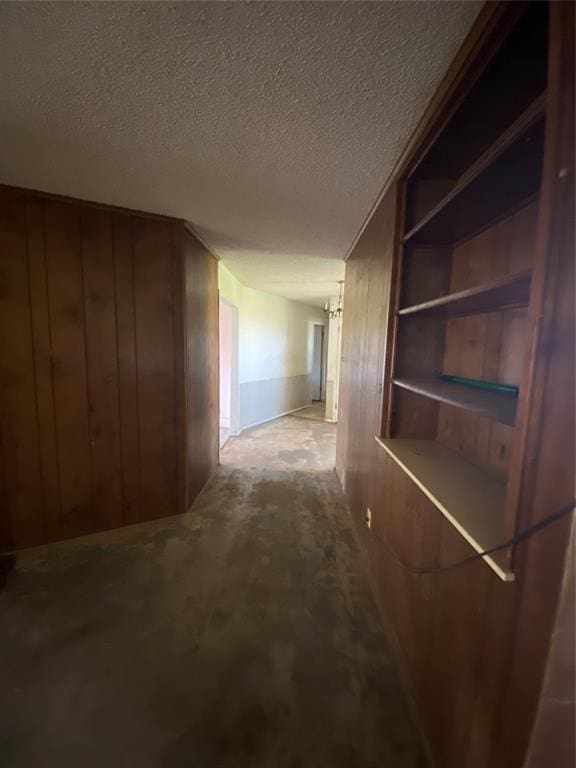 20403 E County Road 1567, Altus, OK 73521 - corridor featuring wooden walls, a textured ceiling, and built in features