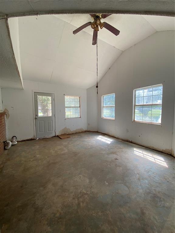 20403 E County Road 1567, Altus, OK 73521 - empty room with a ceiling fan, vaulted ceiling, and unfinished concrete flooring