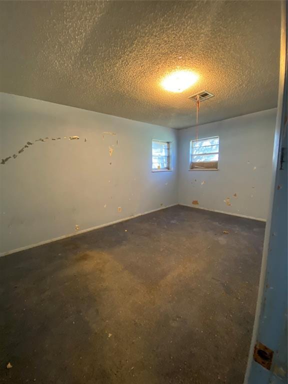 20403 E County Road 1567, Altus, OK 73521 - spare room with a textured ceiling and concrete flooring