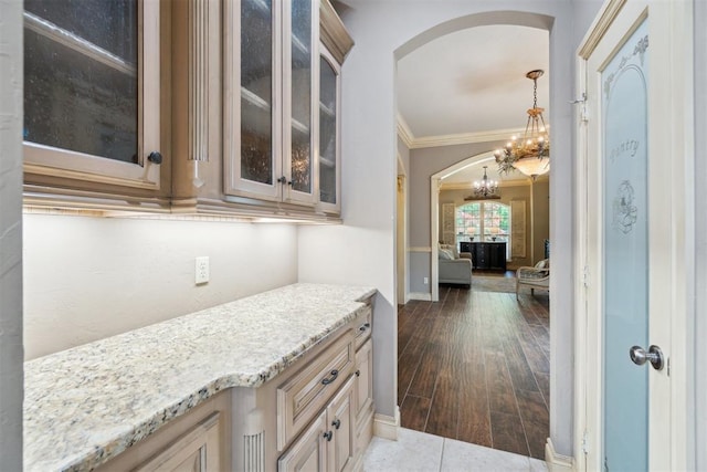 20180 Elm St, Harrah, OK 73045 - bar featuring arched walkways, a chandelier, crown molding, pendant lighting, and baseboards