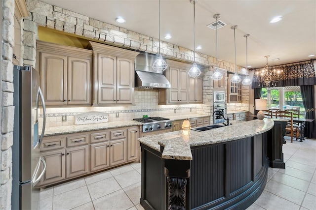 20180 Elm St, Harrah, OK 73045 - kitchen featuring stainless steel appliances, wall chimney exhaust hood, a chandelier, tasteful backsplash, and a sink