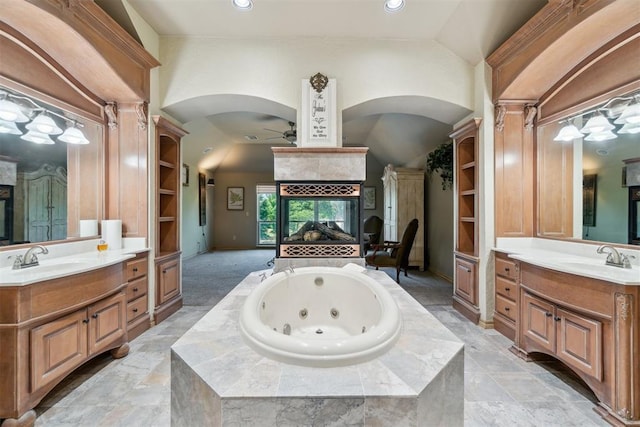 20180 Elm St, Harrah, OK 73045 - bathroom featuring a ceiling fan, a tiled fireplace, two vanities, a tub with jets, and recessed lighting