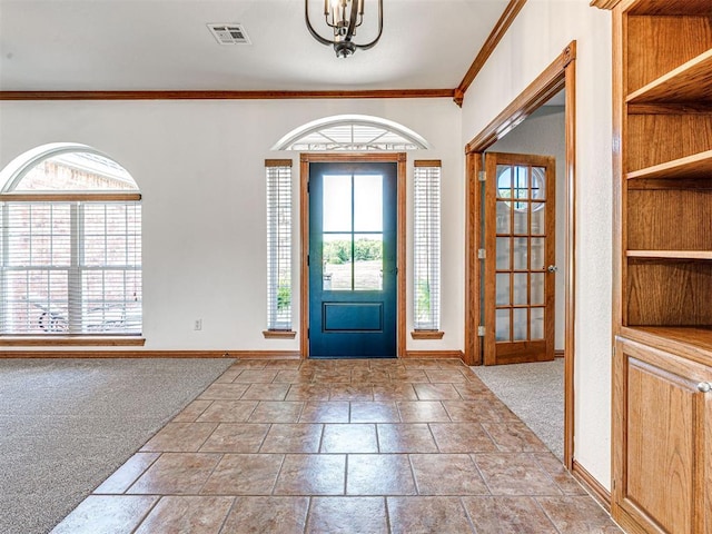 349412 E 840th Rd, Stroud, OK 74079 - carpeted entryway featuring baseboards, crown molding, a chandelier, and stone tile floors