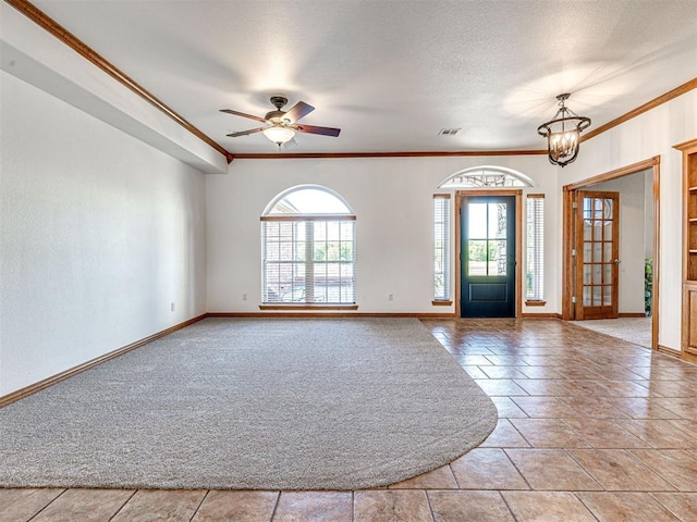 349412 E 840th Rd, Stroud, OK 74079 - carpeted entrance foyer with crown molding, baseboards, a ceiling fan, and a chandelier