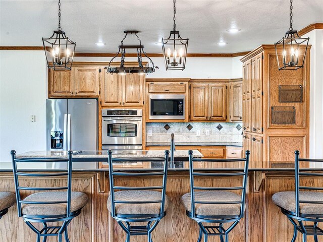 349412 E 840th Rd, Stroud, OK 74079 - kitchen featuring stainless steel appliances, backsplash, pendant lighting, a chandelier, and crown molding