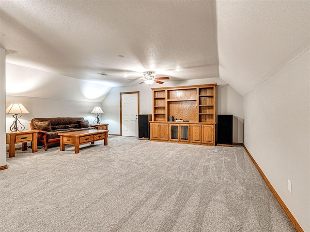 349412 E 840th Rd, Stroud, OK 74079 - living area featuring vaulted ceiling, light colored carpet, baseboards, a textured ceiling, and a ceiling fan