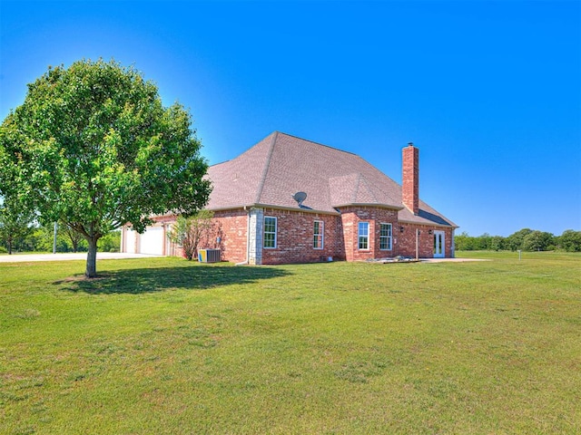 349412 E 840th Rd, Stroud, OK 74079 - view of front of home featuring a garage, a chimney, brick siding, and a front yard