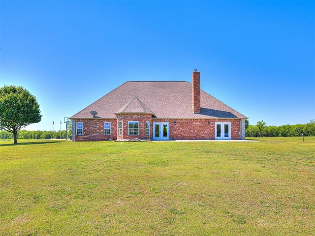 349412 E 840th Rd, Stroud, OK 74079 - rear view of property featuring french doors, a lawn, and a chimney