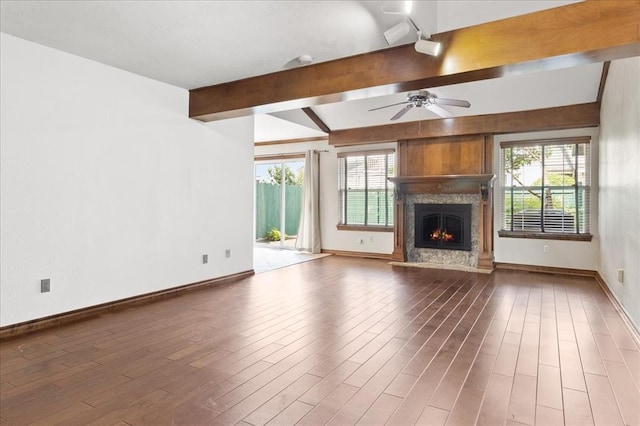 5839 Hefner Village Ct, Oklahoma City, OK 73162 - unfurnished living room featuring beam ceiling, healthy amount of natural light, wood finished floors, a high end fireplace, and a ceiling fan