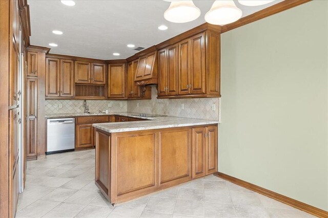 5839 Hefner Village Ct, Oklahoma City, OK 73162 - kitchen with stainless steel dishwasher, a peninsula, a sink, brown cabinetry, and backsplash