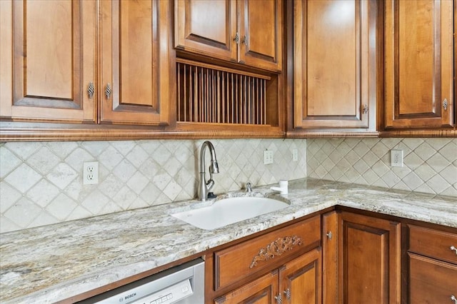 5839 Hefner Village Ct, Oklahoma City, OK 73162 - kitchen featuring a sink, dishwasher, light stone countertops, decorative backsplash, and brown cabinets