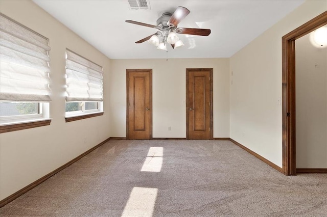 5839 Hefner Village Ct, Oklahoma City, OK 73162 - unfurnished bedroom with light carpet, baseboards, and a ceiling fan