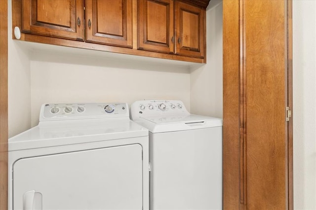 5839 Hefner Village Ct, Oklahoma City, OK 73162 - laundry area with cabinet space and washer and clothes dryer