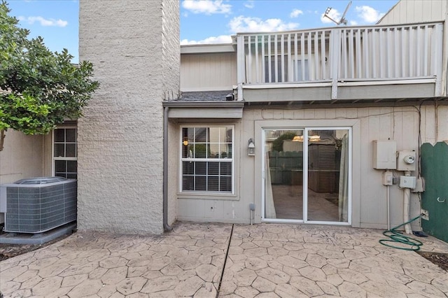 5839 Hefner Village Ct, Oklahoma City, OK 73162 - back of house featuring a balcony, central AC, a patio area, and a chimney