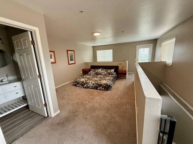 carpeted bedroom featuring baseboards
