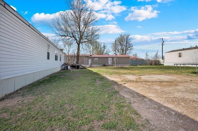 220 N Vernon Ave, Hinton, OK 73047 - view of grassy yard with a trampoline