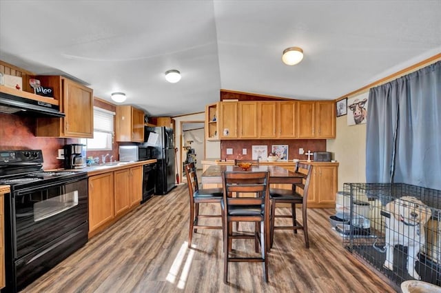 220 N Vernon Ave, Hinton, OK 73047 - kitchen featuring black appliances, open shelves, under cabinet range hood, wood finished floors, and a sink