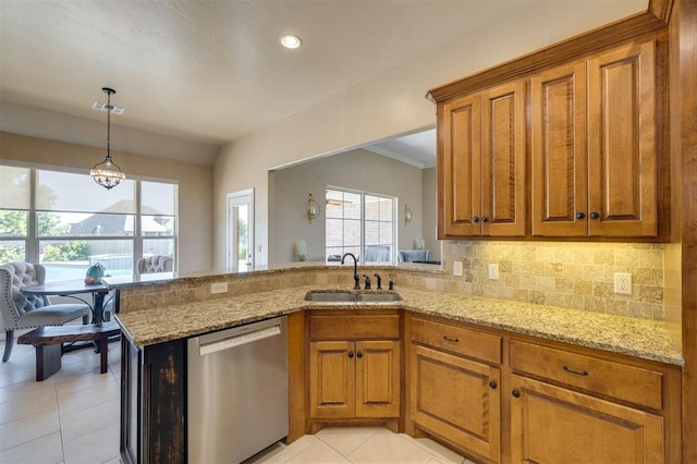 239 Brandon Cir, Goldsby, OK 73093 - kitchen with stainless steel dishwasher, a sink, brown cabinets, light stone countertops, and recessed lighting