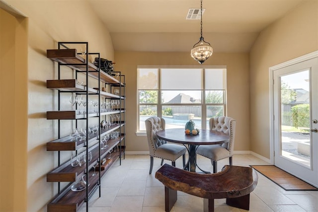 239 Brandon Cir, Goldsby, OK 73093 - dining space with light tile patterned floors, a chandelier, vaulted ceiling, and baseboards