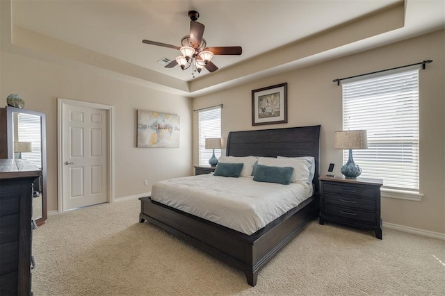 239 Brandon Cir, Goldsby, OK 73093 - bedroom with a raised ceiling, light colored carpet, baseboards, and a ceiling fan