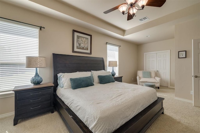 239 Brandon Cir, Goldsby, OK 73093 - bedroom featuring light carpet, baseboards, a ceiling fan, and a raised ceiling