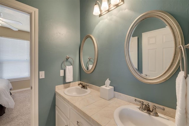 239 Brandon Cir, Goldsby, OK 73093 - ensuite bathroom with double vanity, a ceiling fan, and baseboards