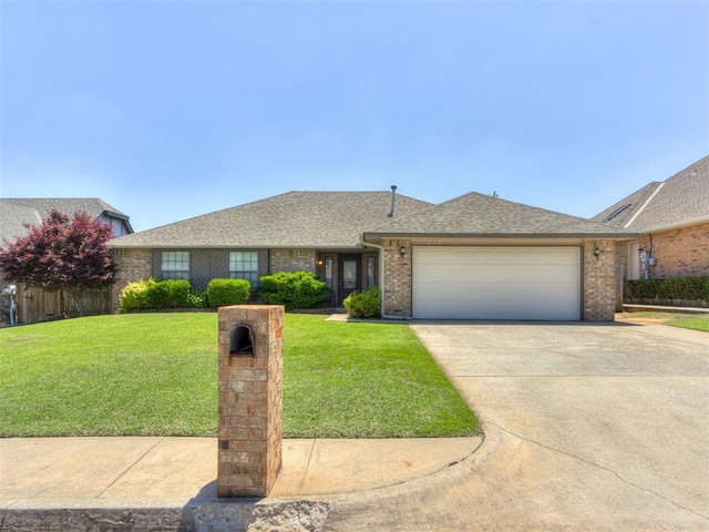 312 Carlsbad Ct, Yukon, OK 73099 - ranch-style house with a front lawn, an attached garage, concrete driveway, brick siding, and a shingled roof